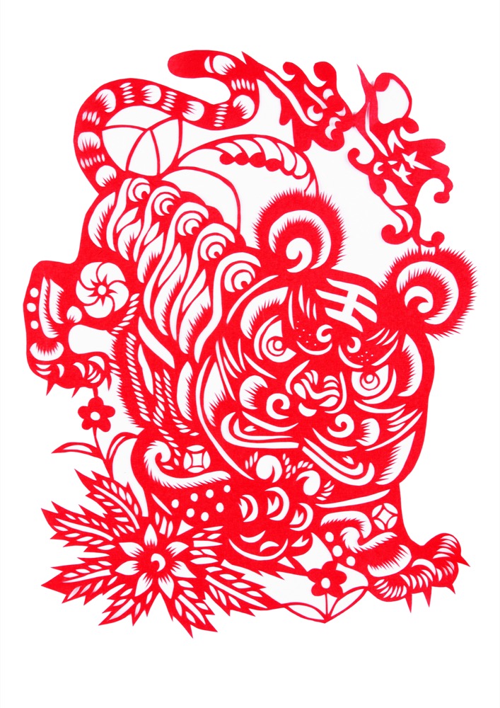 A stylized tiger cut, often pasted near children for protection