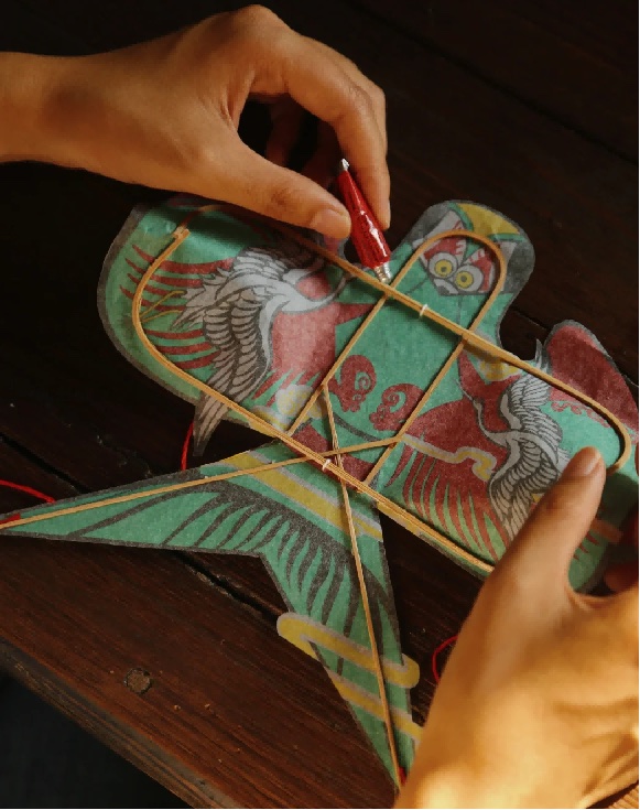 A painted sand swallow kite with crane motifs still on its bamboo frame