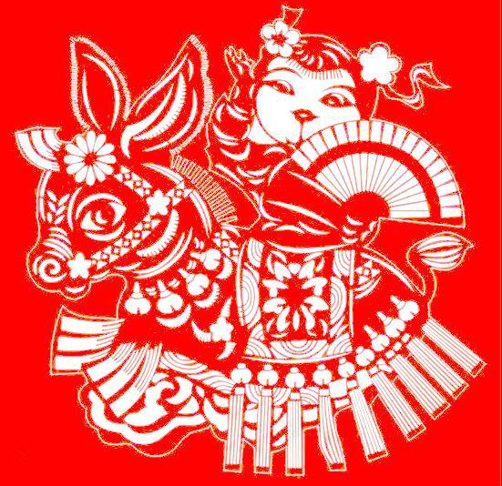 Folk paper-cut motif of a child riding an animal, a common festive image