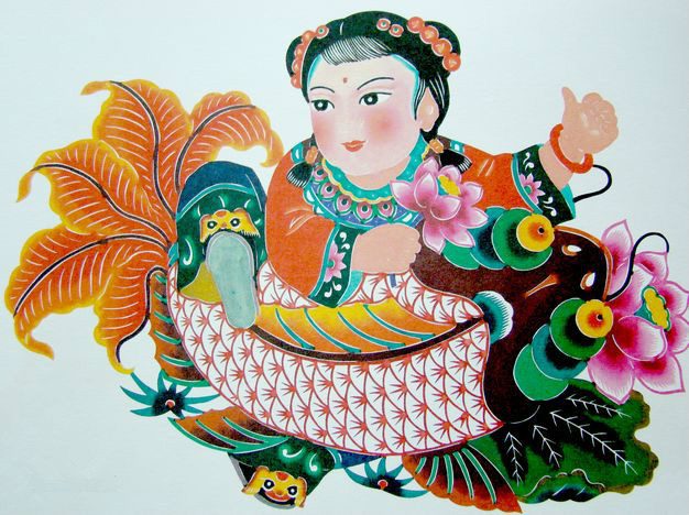 Yuxian-style dyed paper cutting: a child with a giant fish, symbolizing abundance