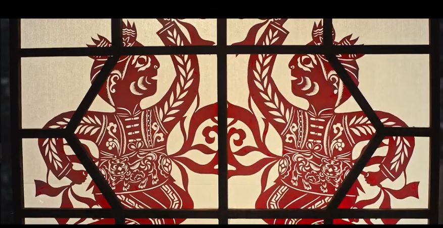 Bold northern-style paper cuts pasted on a courtyard window lattice
