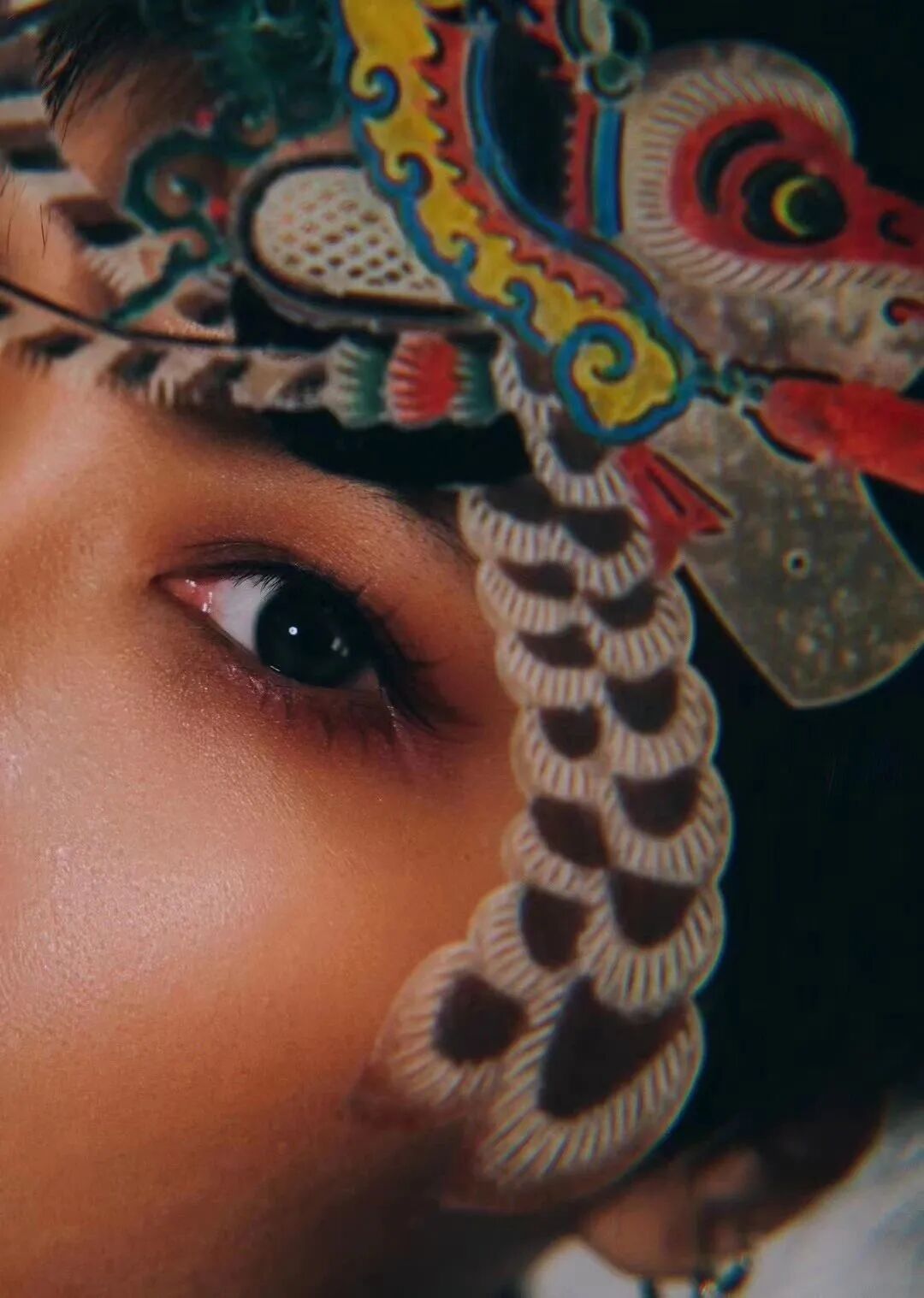 Sun Bingqing behind a painted dragon-head puppet, close to her opera roots