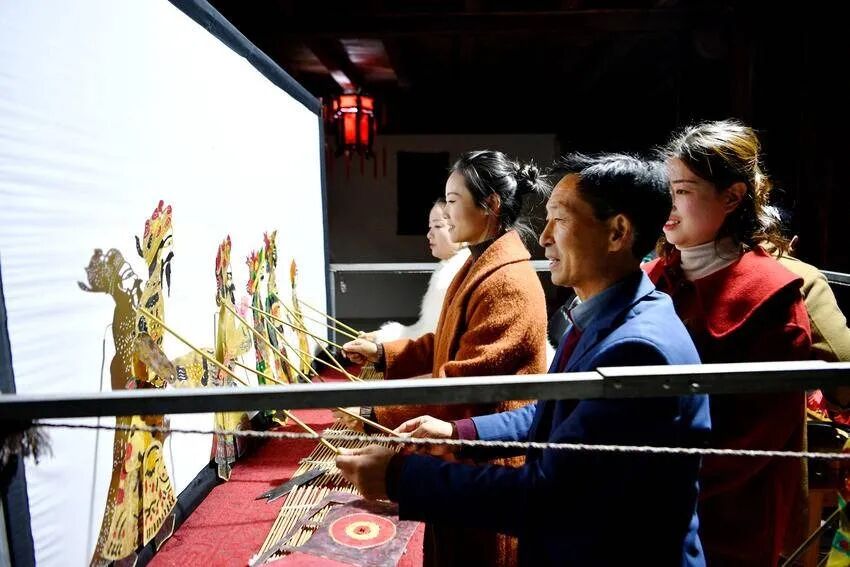 Villagers trying the puppet rods during an evening session at the studio